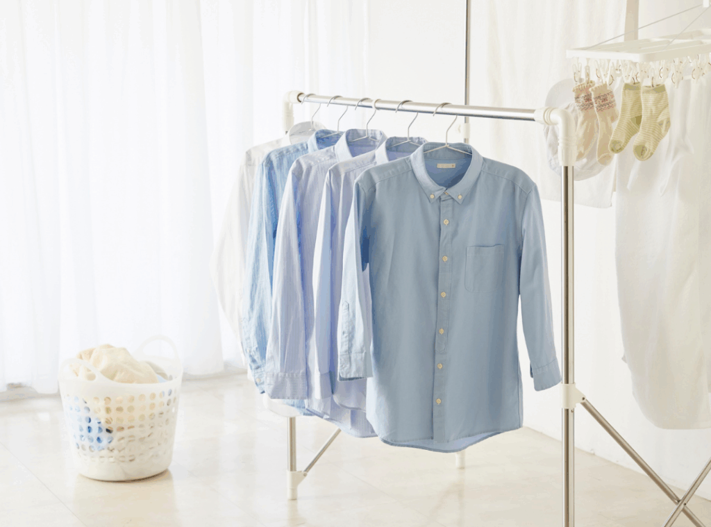 islip dry cleaners White and blue dress shirts hanging on a laundry rack after washing - professional shirt laundering service on Long Islan