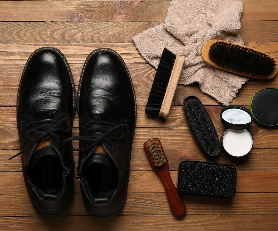 Black leather boots with brushes, polish and shoe care kit