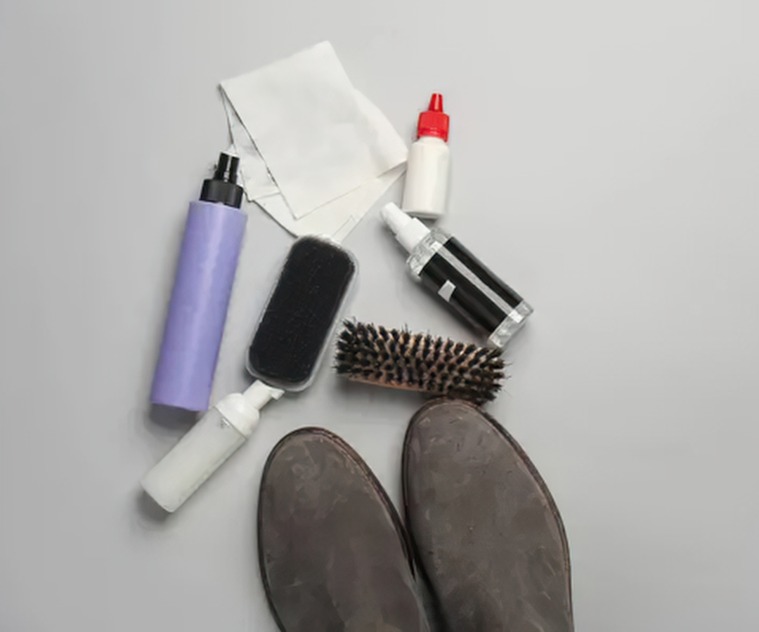 Suede boots with suede brushes and cleaning products